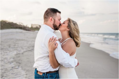 Kissing on beach Satellite Beach during Surprise Proposal