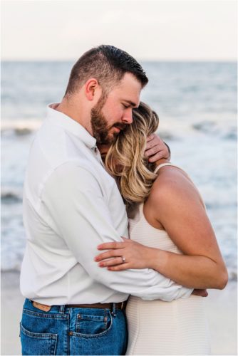 Man hugging girl on beach Satellite Beach Surprise Proposal