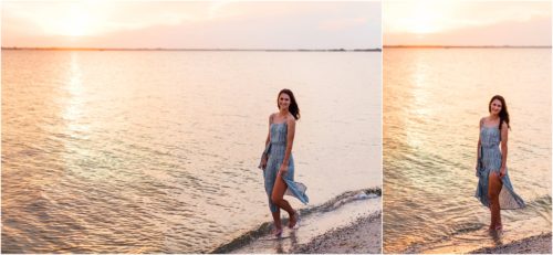 Girl standing in water with orange sunset in the background Melbourne Beach Senior Photography