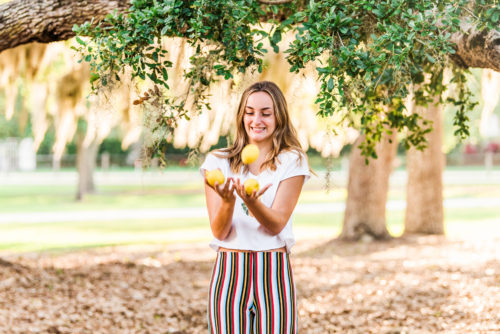 girl tossing lemons Riverside Park Senior Portraits