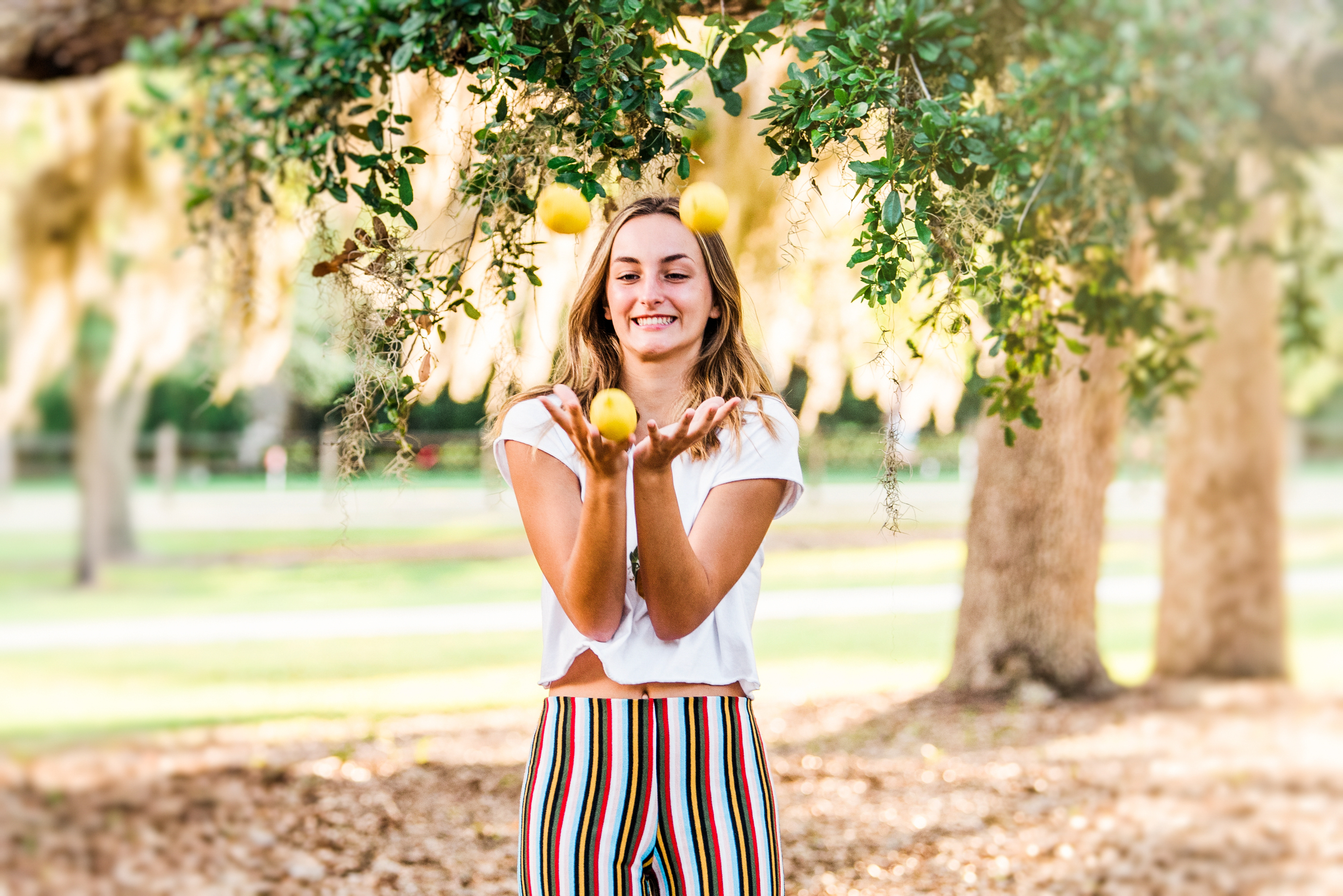 Girl tossing lemons in Riverside park