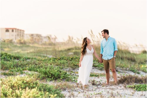 Couple holding hands in dunes Best Engagement Session Beach Locations