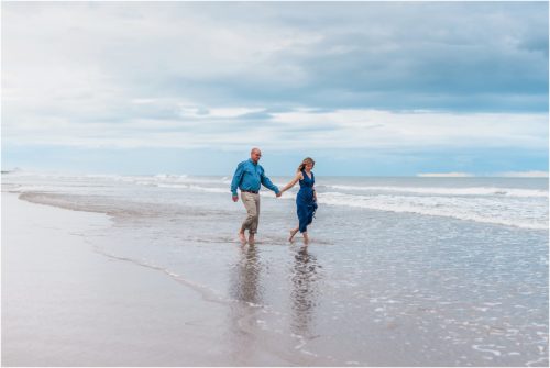 Couple holding hands walking in water on Melbourne Beach Best Engagement Session Beach Locations