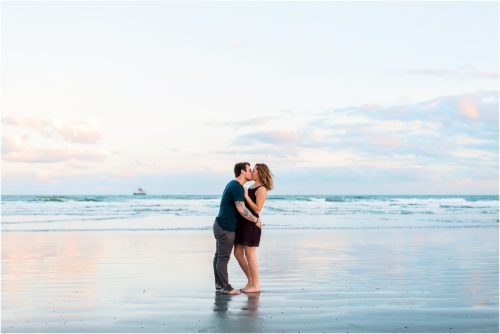 Couple kissing at low tide at Jetty Park Best Engagement Session Beach Locations