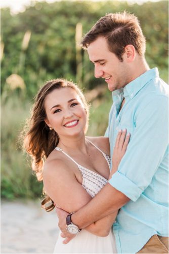 Couple with dunes in background at Cocoa Beach Engagement