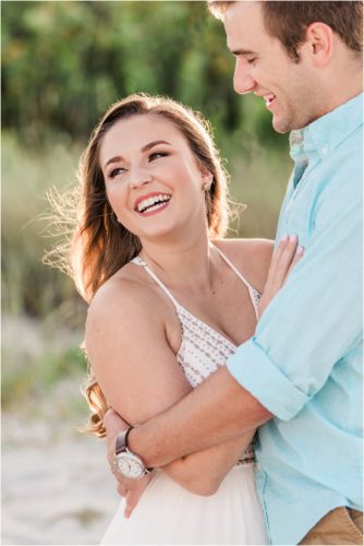 Girl laughing while being hugged on Cocoa Beach