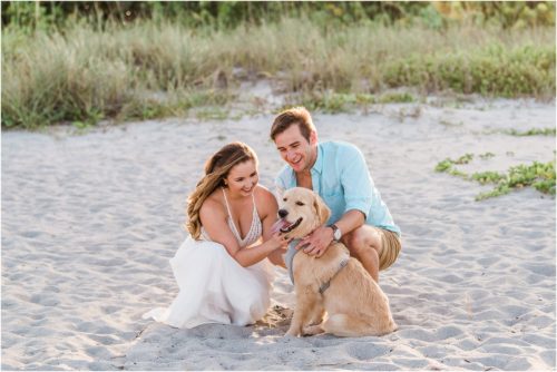 Couple hugging dog