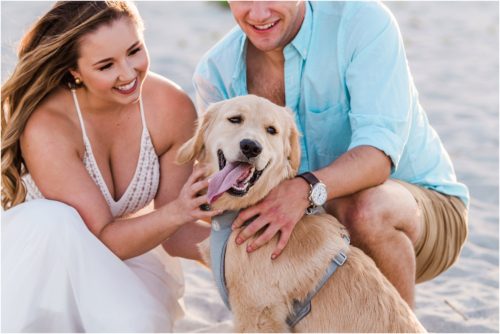 Couple with dog sticking his tongue out