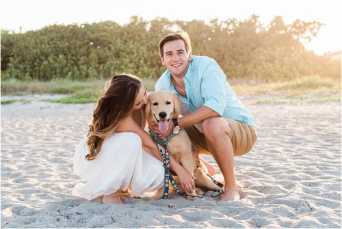 Couple hugging dog