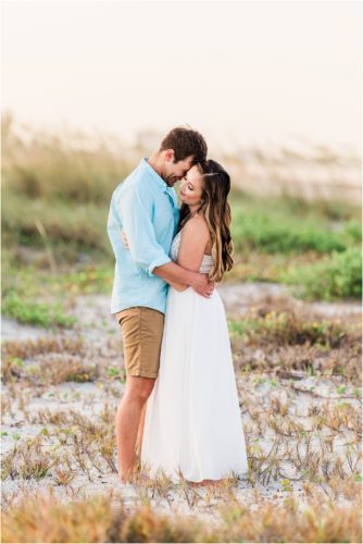 Hugging in the dunes Cocoa Beach Engagement