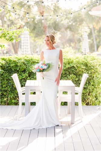 Bride on porch in sheath dress during Melbourne Beach vow renewal inspired shoot