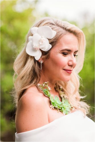 Bride in floral necklace during Melbourne Beach vow renewal inspired shoot