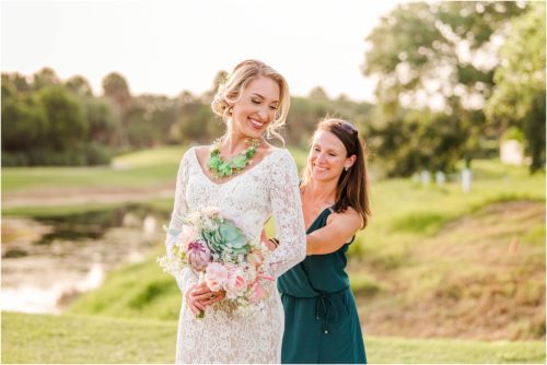 Fifth Ave Bridal owner fixing dress during Melbourne Beach vow renewal inspired shoot