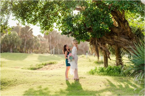 Fifth Ave Bridal owner fixing gown during Melbourne Beach vow renewal inspired shoot