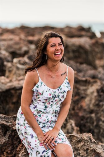 Bride to be laughing while sitting on rocks House of Refuge Engagement session
