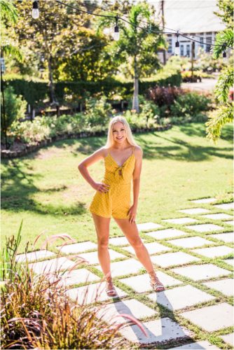 Girl standing on grass squares during Rockledge Gardens Senior Pictures