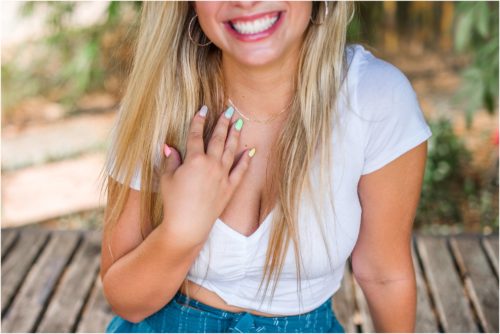 Senior showing off multi colored nails