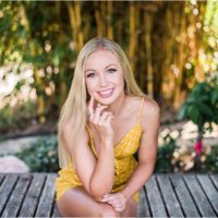 Girl smiling and resting on elbow Rockledge Gardens Senior Pictures