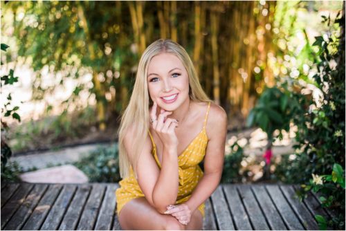 Girl smiling and resting on elbow Rockledge Gardens Senior Pictures