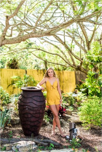 Girl leaning on large vase in Rockledge gardens
