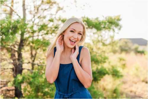 Girl laughing and touching her face during Rockledge Gardens Senior Pictures