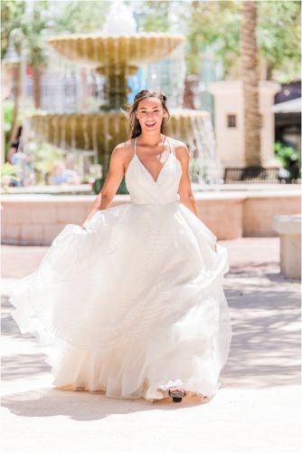Bride laughing and walking in white Haley Paige wedding dress at the Avenues in Viera. Melbourne Florida Wedding Photographer