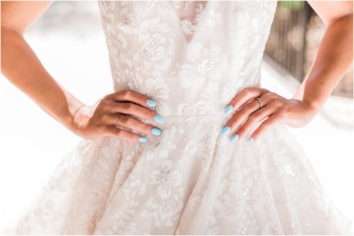 Bride in Haley Paige wedding dress with blue fingernails