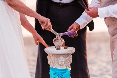 Sand ceremony with colored sand during sunrise wedding