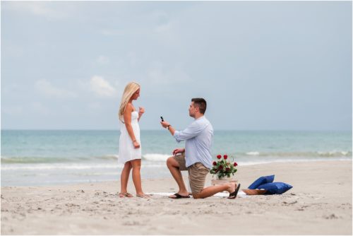 Man down on one knee asking girl to marry him after Surprise Proposal on Cocoa Beach