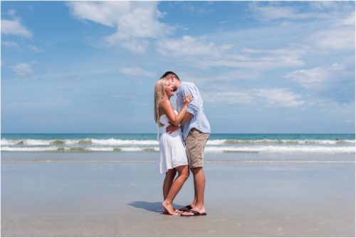 Couple hugging and laughing on beach