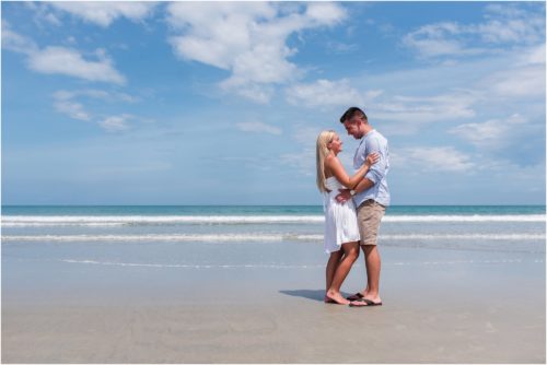 Couple hugging by the edge of the ocean