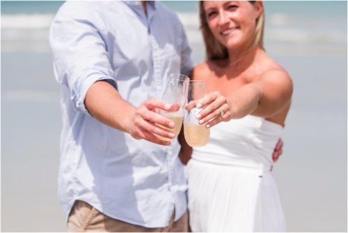 Couple clinking champagne glasses after Surprise Proposal