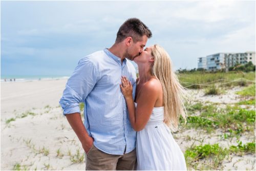 Couple kissing on beach after getting engaged