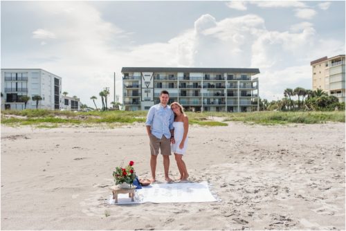 Couple standing next to blanket on Cocoa Beach