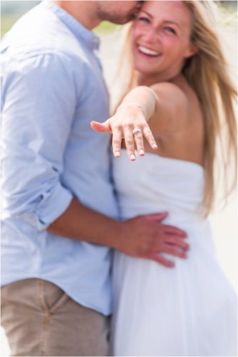 Showing off her engagement ring after Surprise Proposal on Cocoa Beach