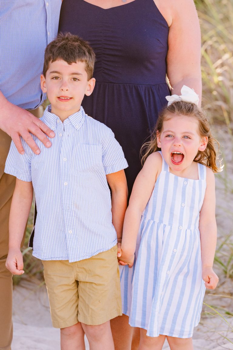 two young children laughing during a family session on melbourne beach