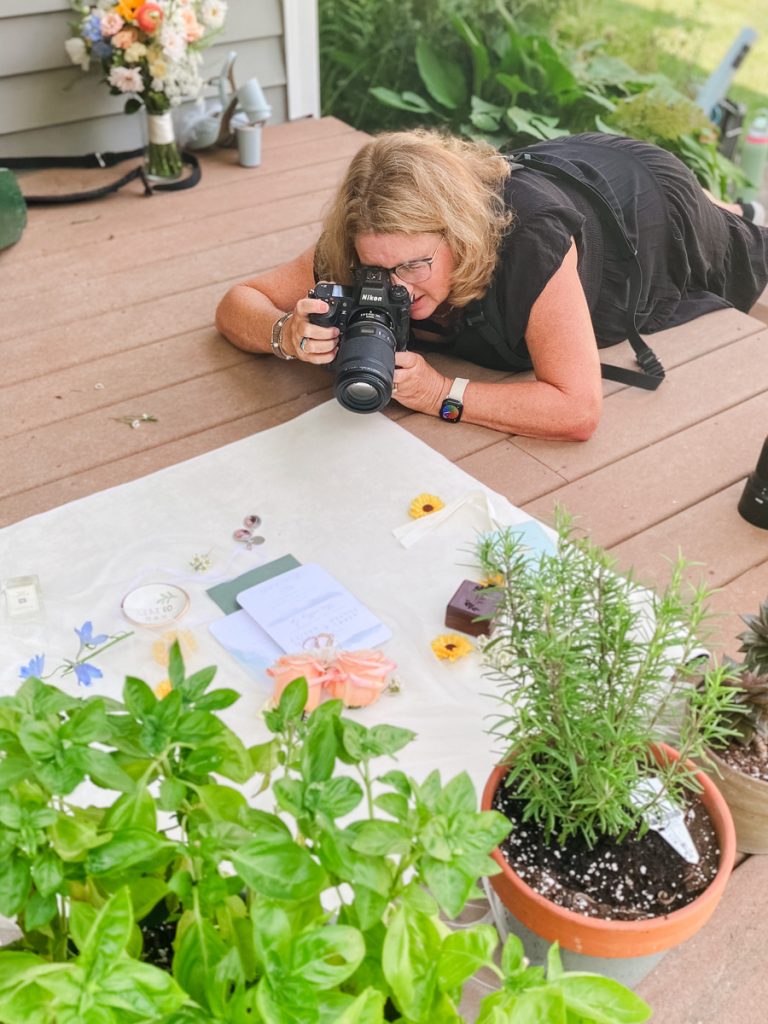 Liz Cowie assembling and photographing a flatly at a wedding in Pawling New York