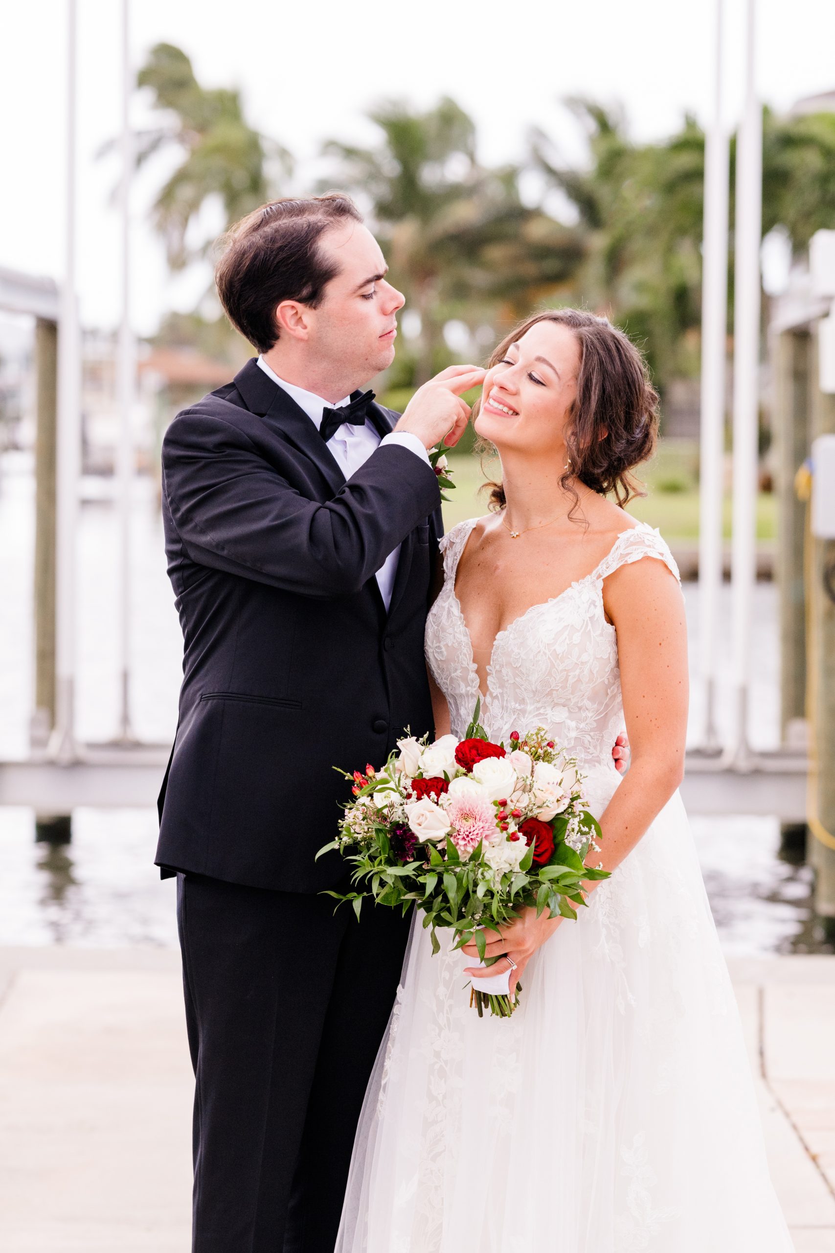 Man moving a strand of hair from his wife's face