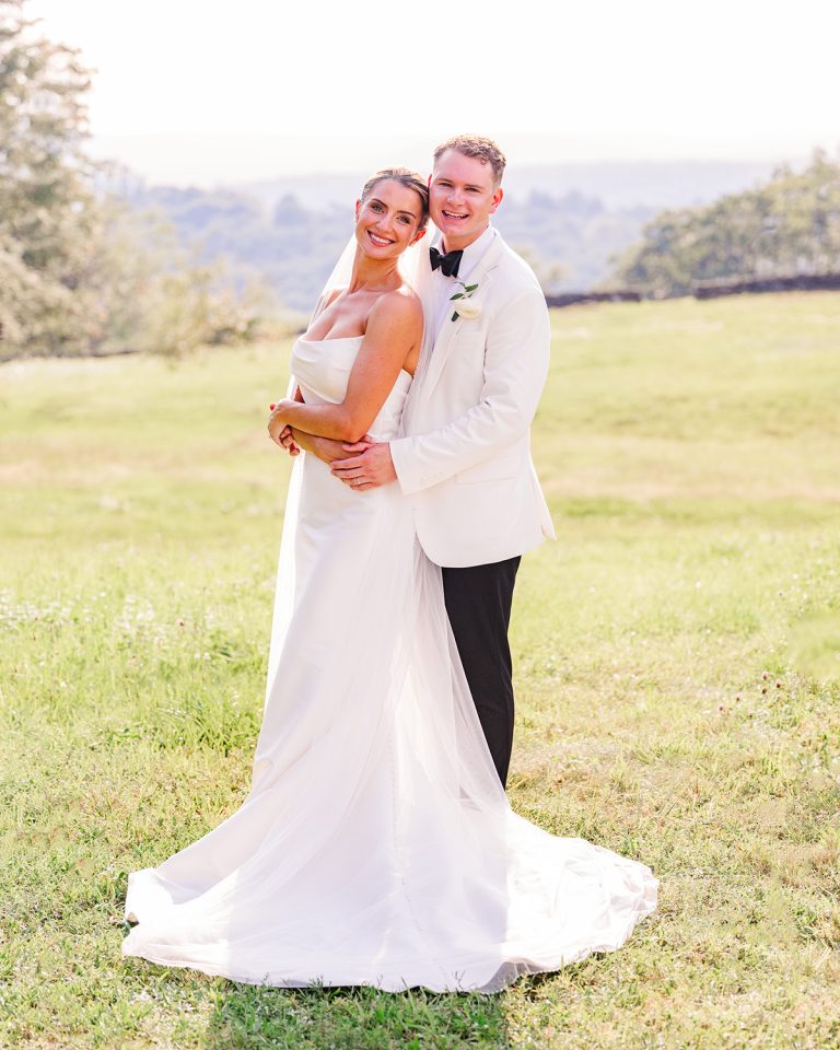 Bride and groom posing together outdoors on their New York wedding day