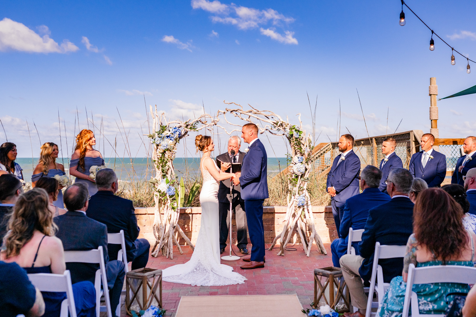 Bride and groom exchanging vows during their Harbour House Oceanfront wedding ceremony.