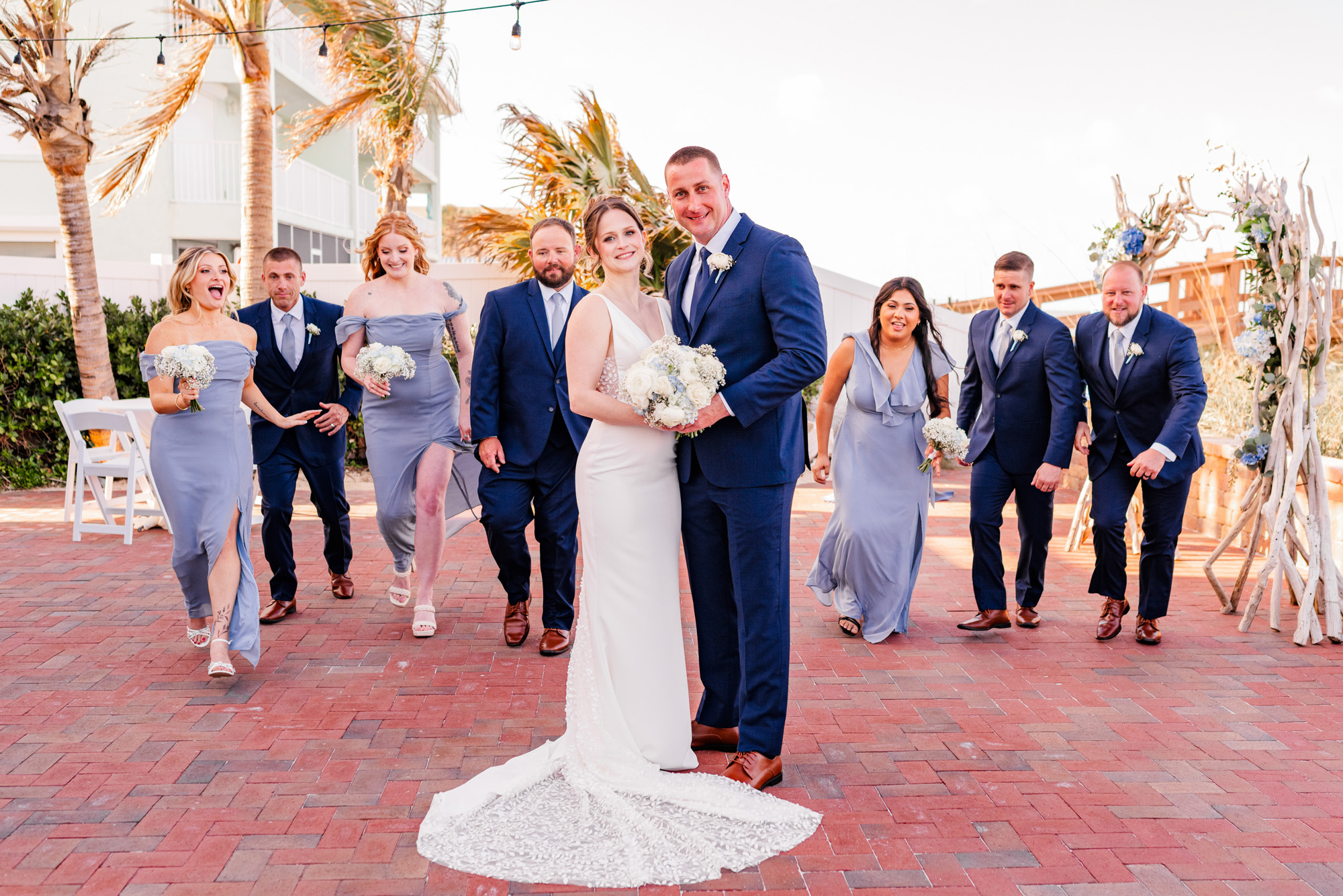 Bride and groom surrounded by their wedding party after an oceanfront ceremony at Harbour House.