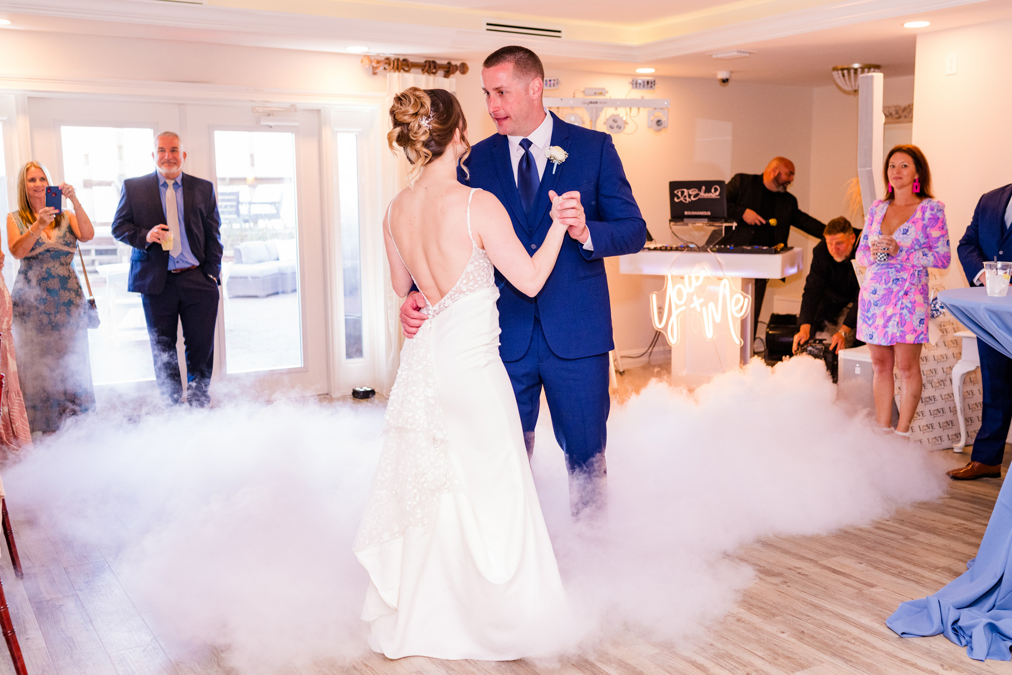 Bride and groom sharing their first dance in low-lying fog at Harbour House Oceanfront.
