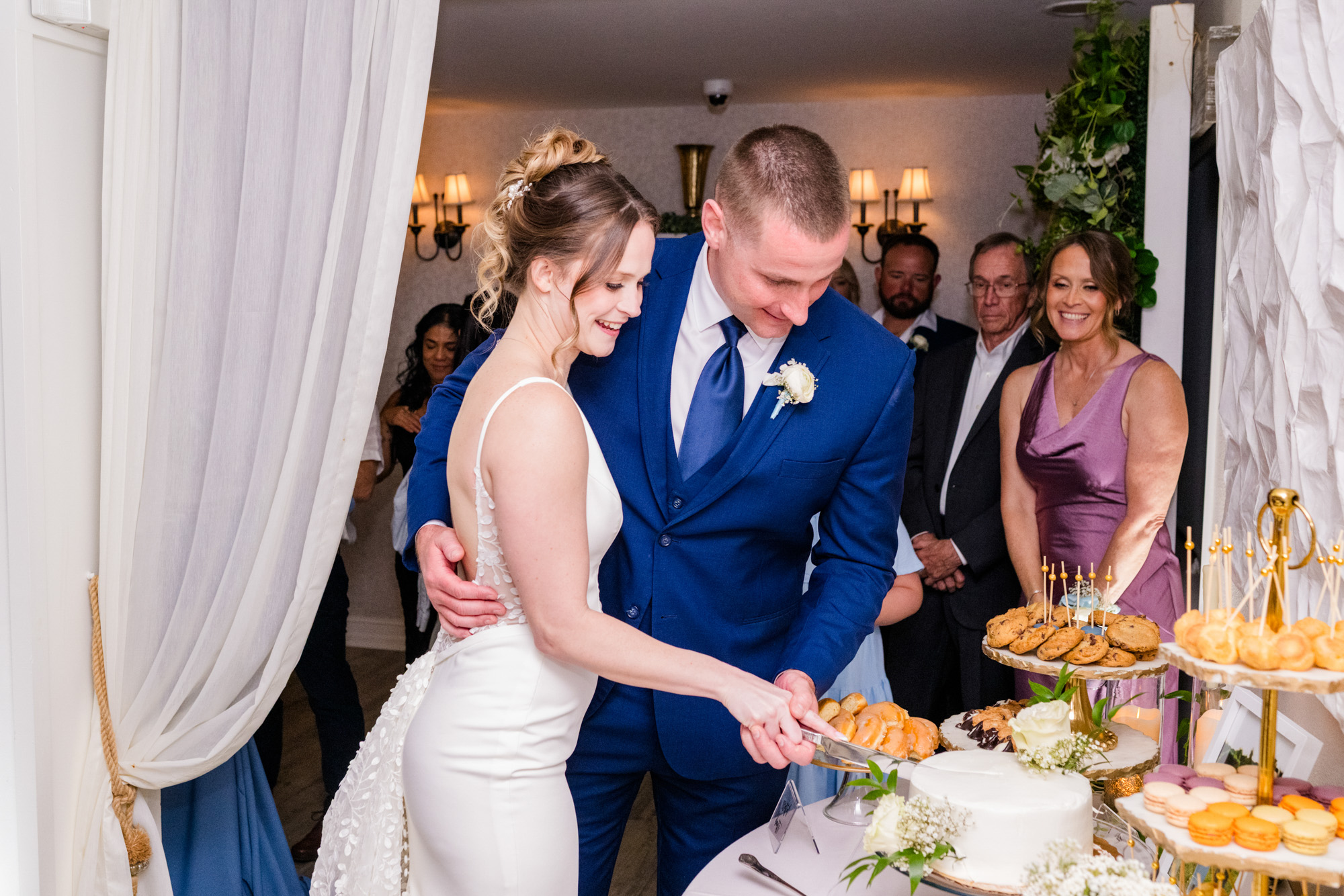 Bride and groom cutting their wedding cake together during the reception.