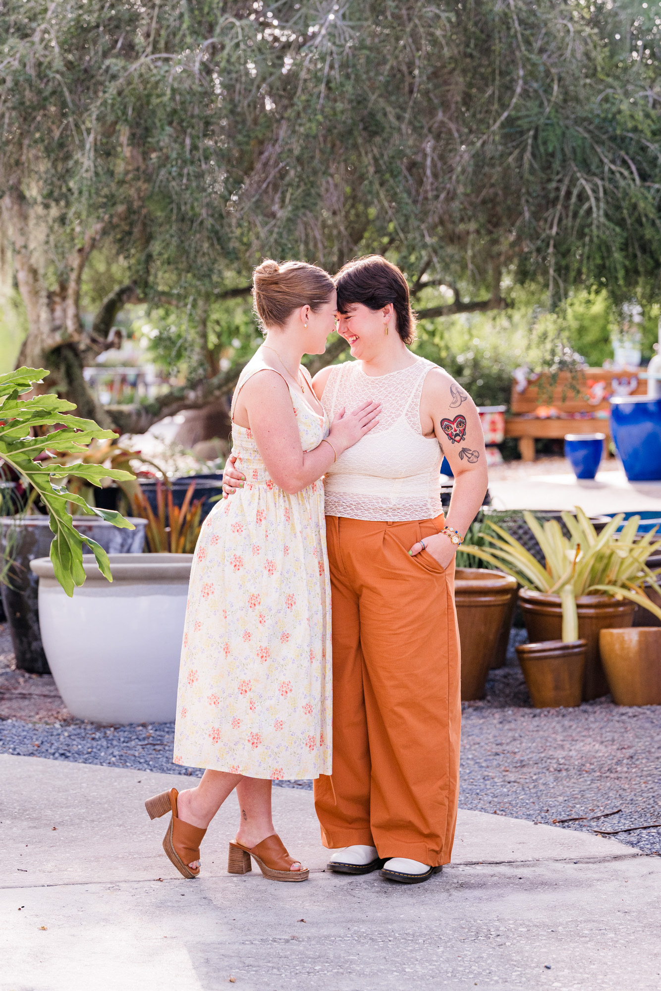 Same sex couple dressed in creme and orange at their Rockledge gardens engagement session