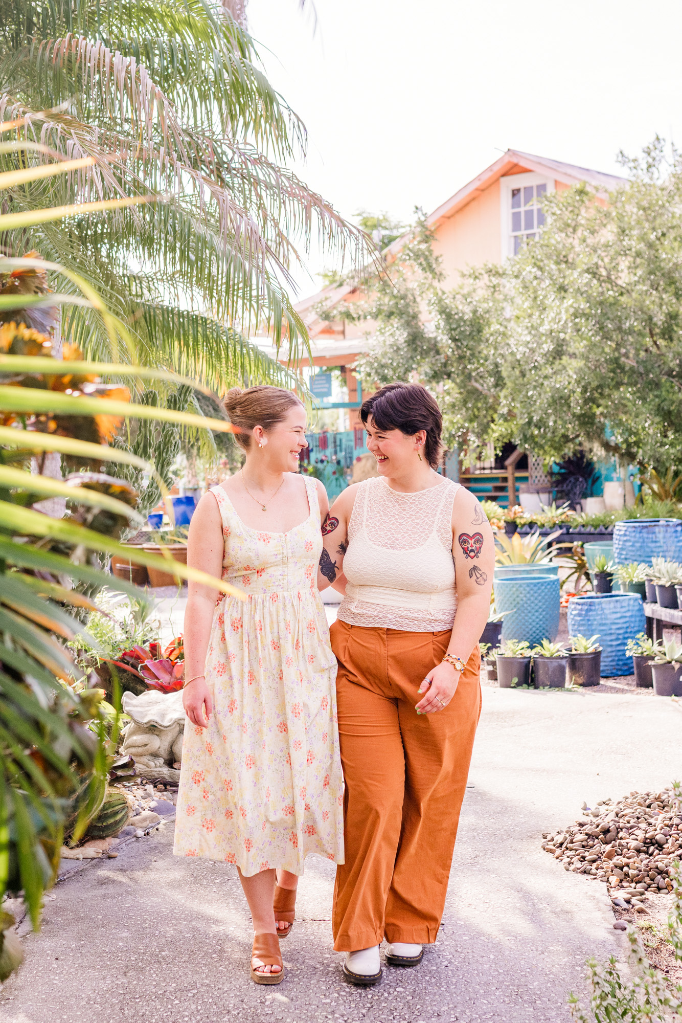 Same sex couple walking with foliage in front of them