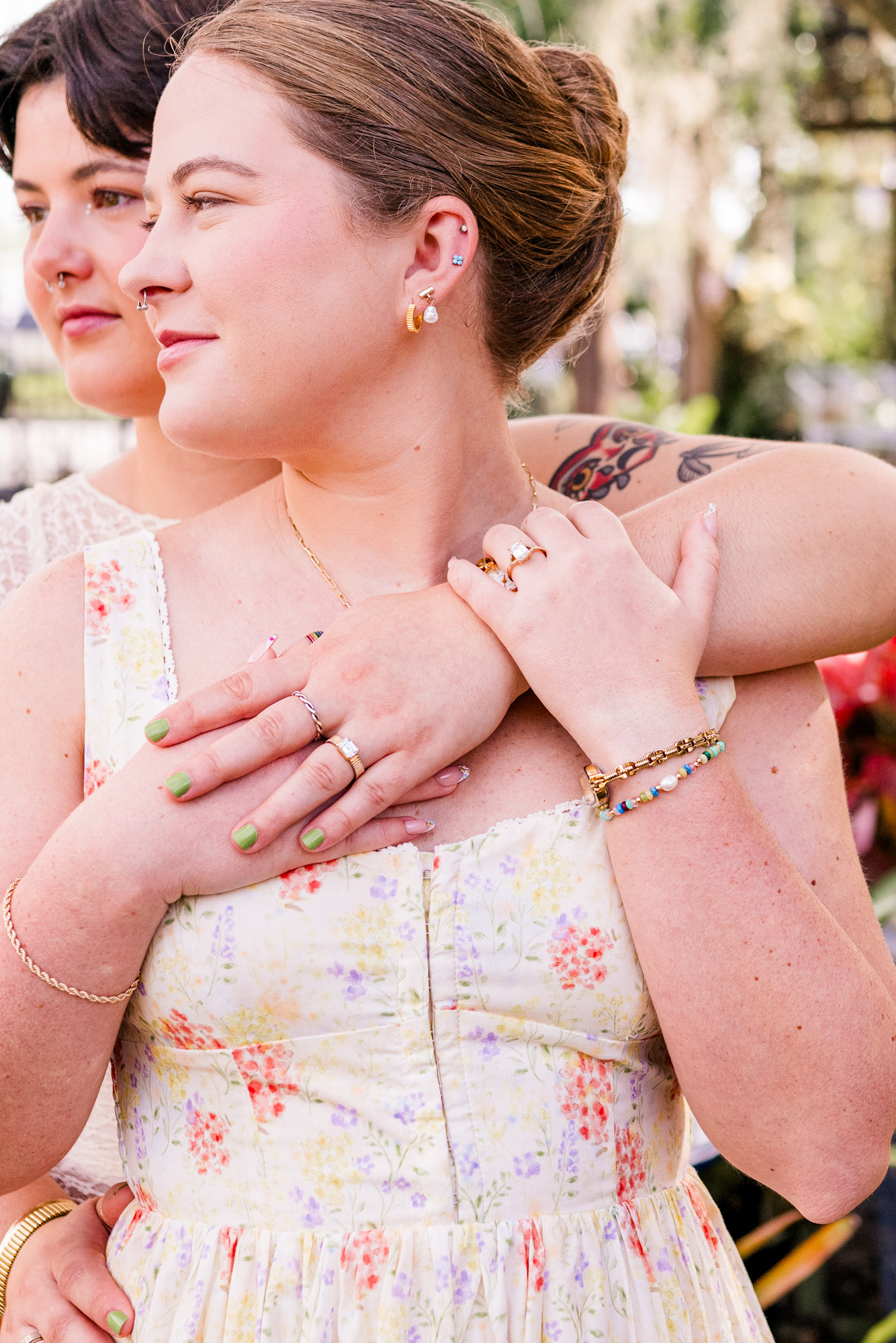 couple with arms around each other showing rings