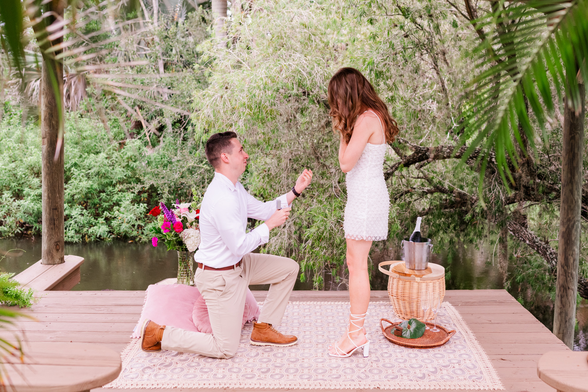 Man down on his knee proposing at Up the Creek Farms