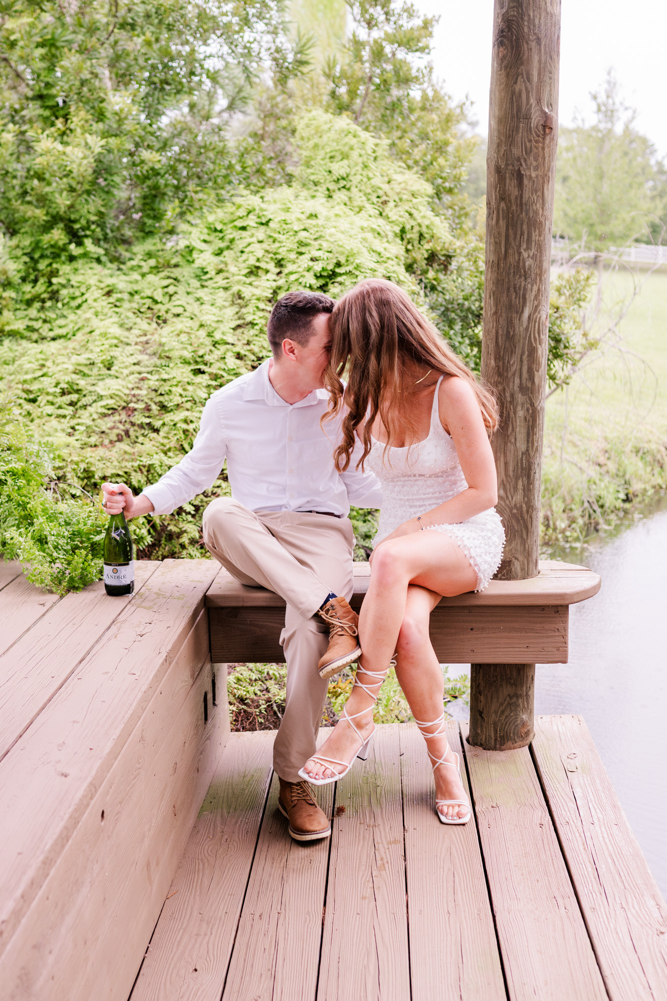 couple popping champagne