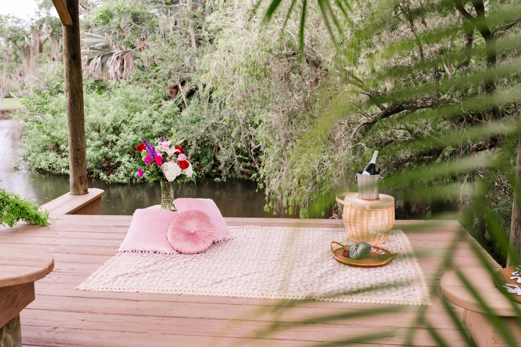 blanket and pink flowers setup for Up the Creek Farms proposal