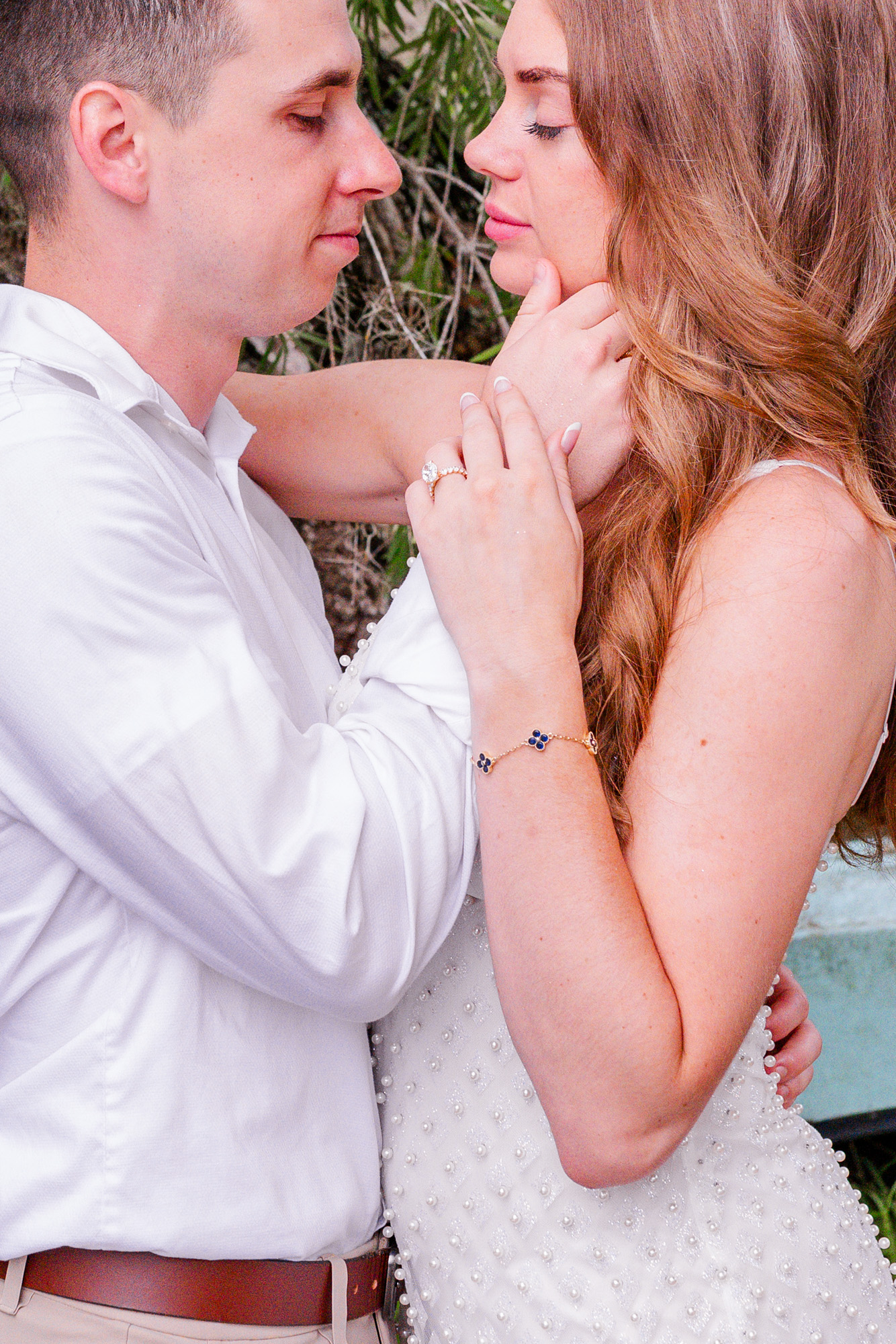 woman holding onto mans hand